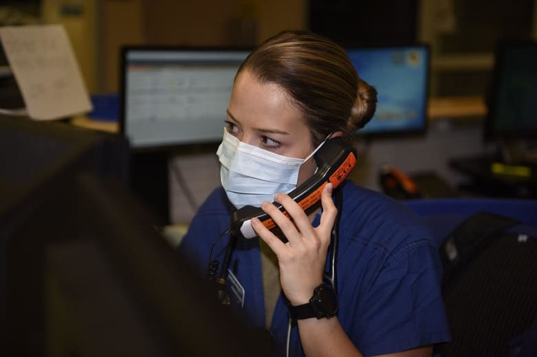 Masked healthcare professional on the phone
