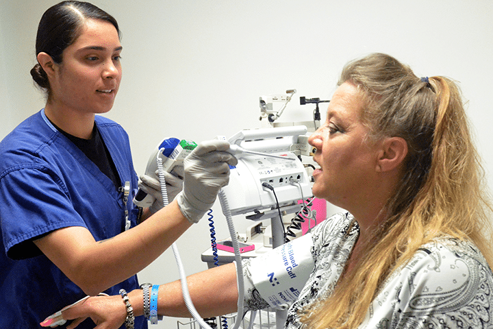Medical assistant taking a patient's vitals