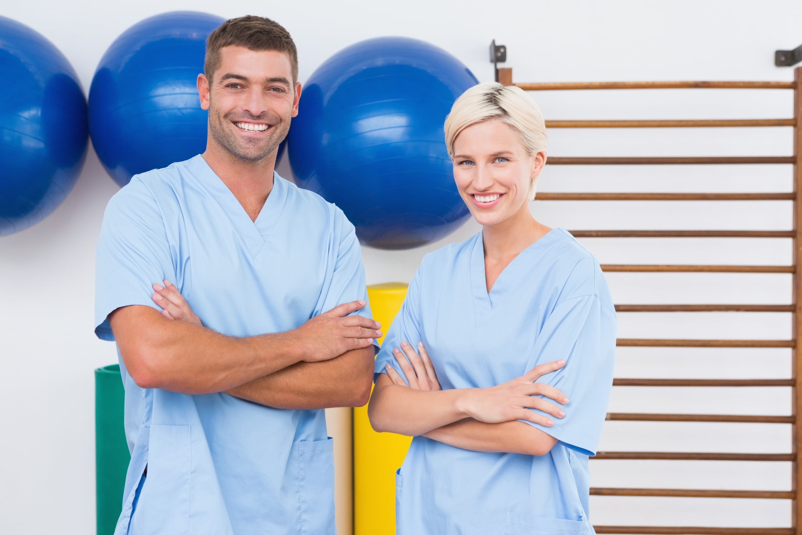 Team of smiling therapists with arms crossed
