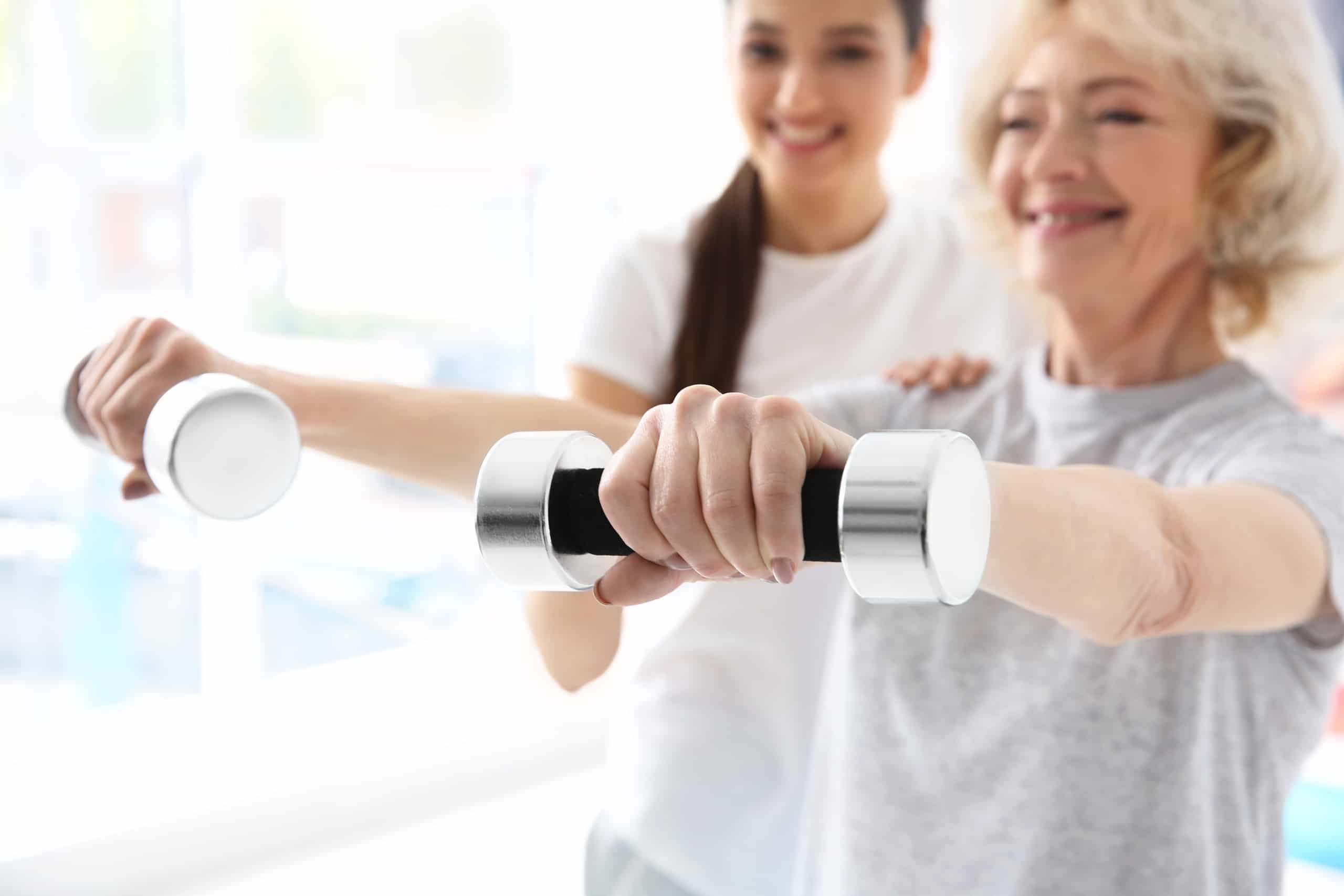 Physiotherapist working with elderly patient