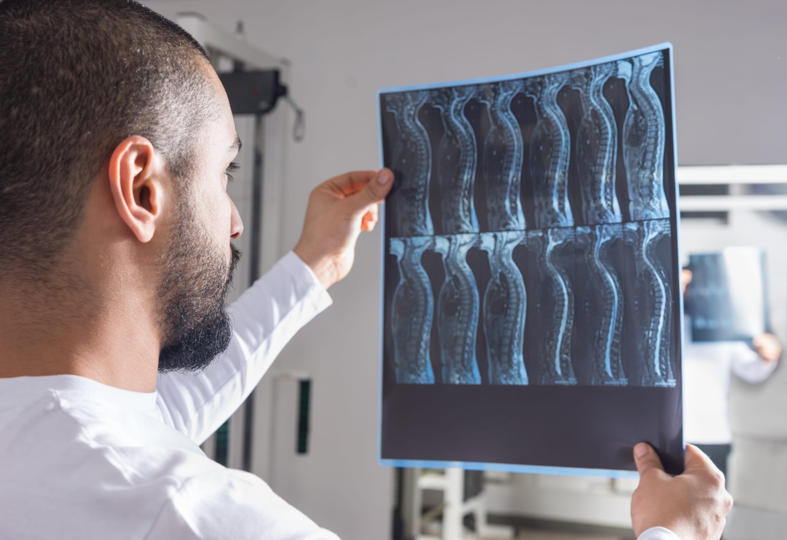 Medical professional analyzing X-ray image