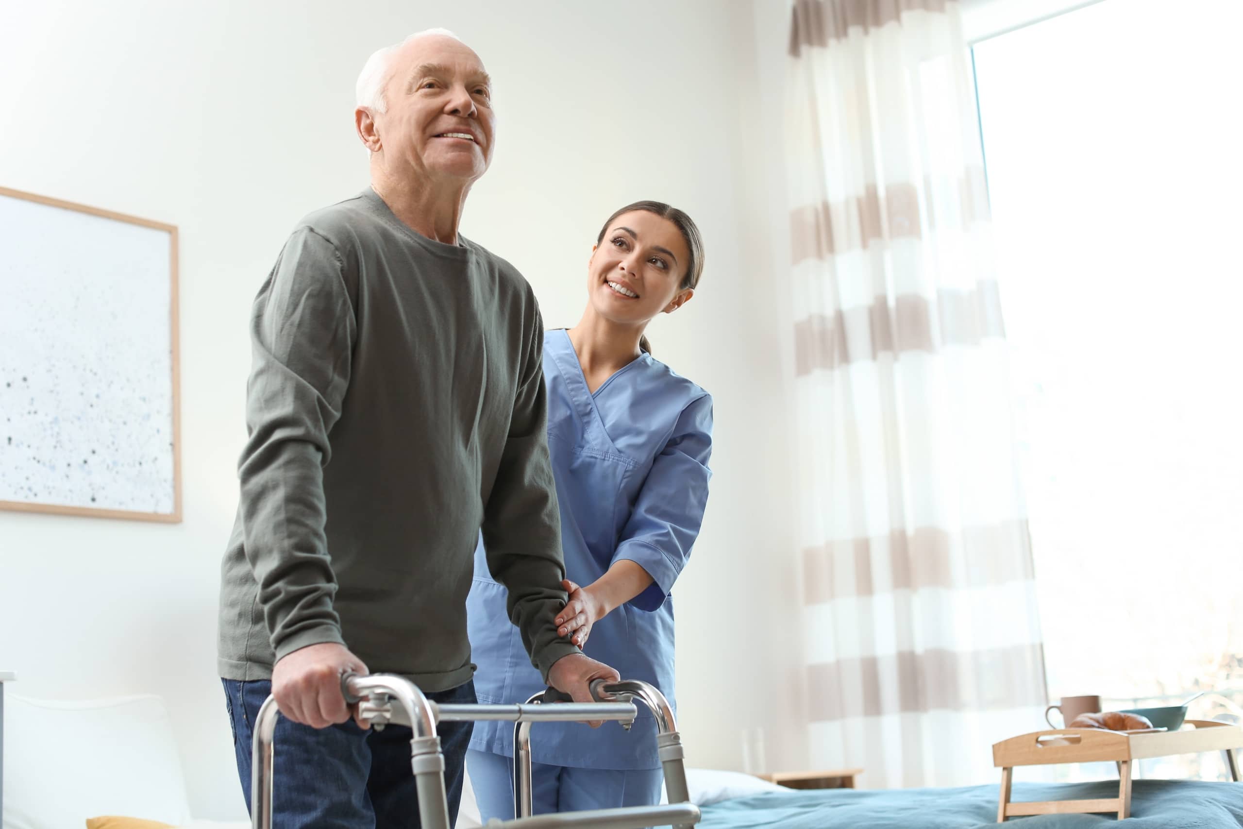 Care worker assisting an elderly man