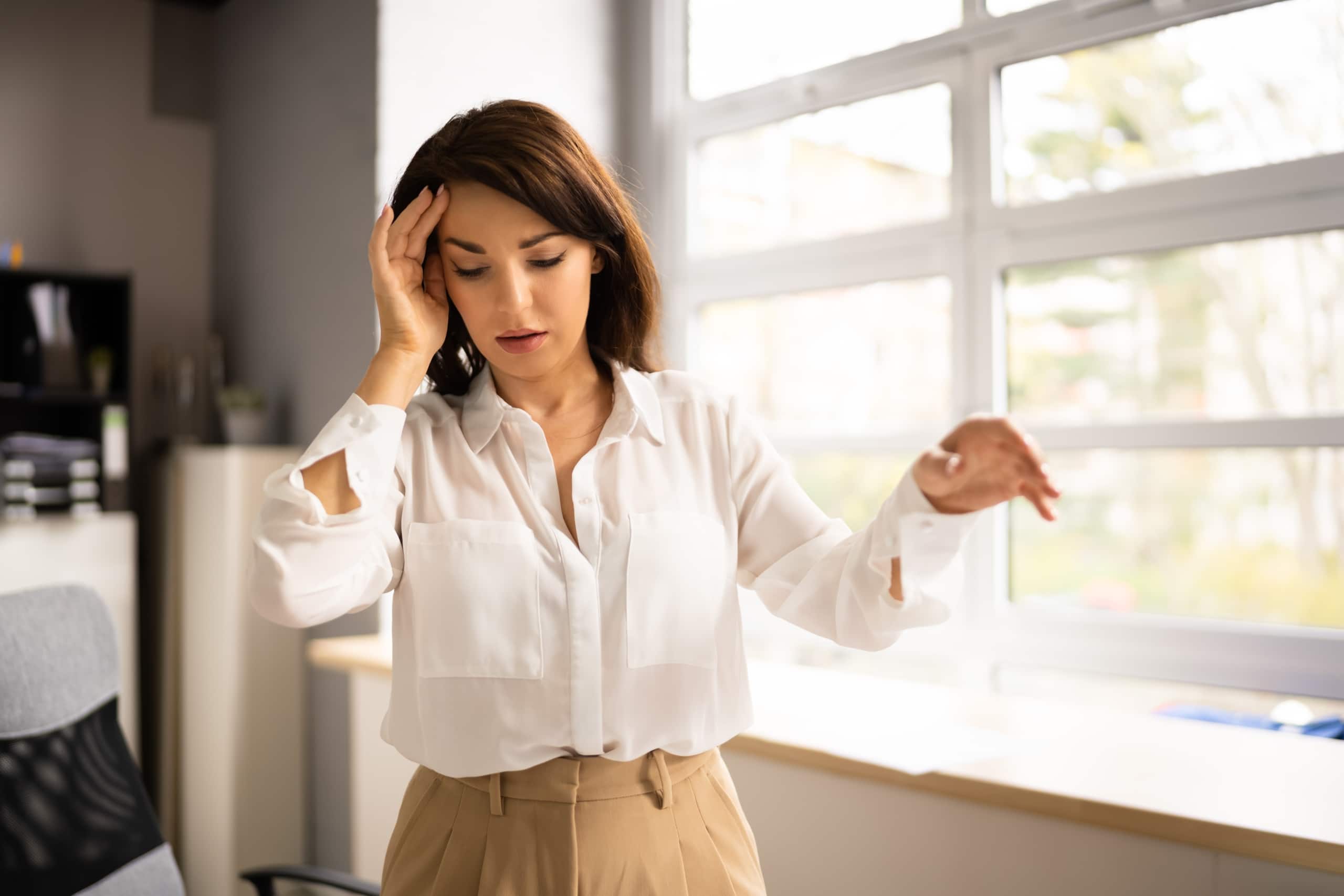 Woman clutching her head in pain
