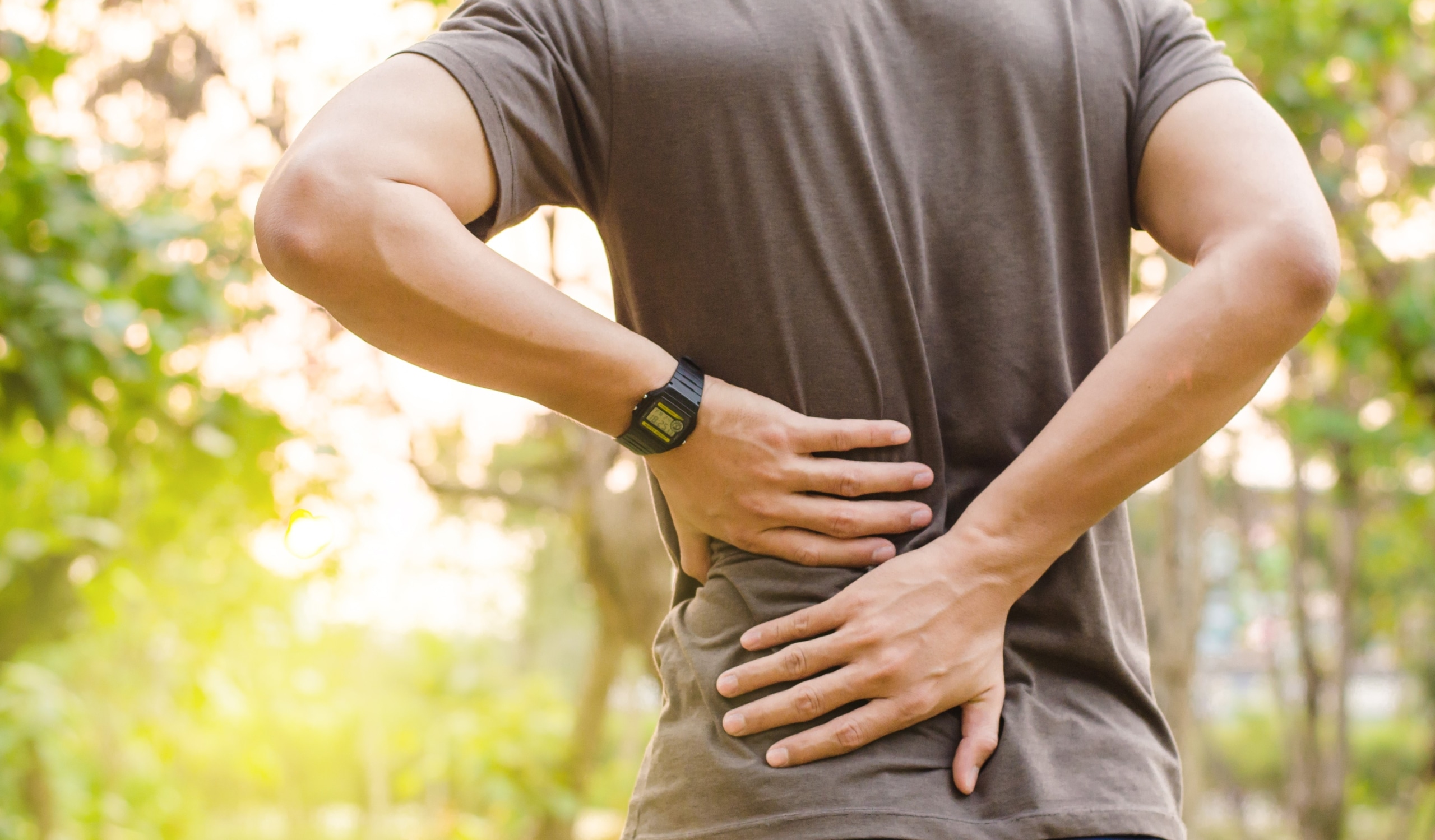 Man gripping his back in pain