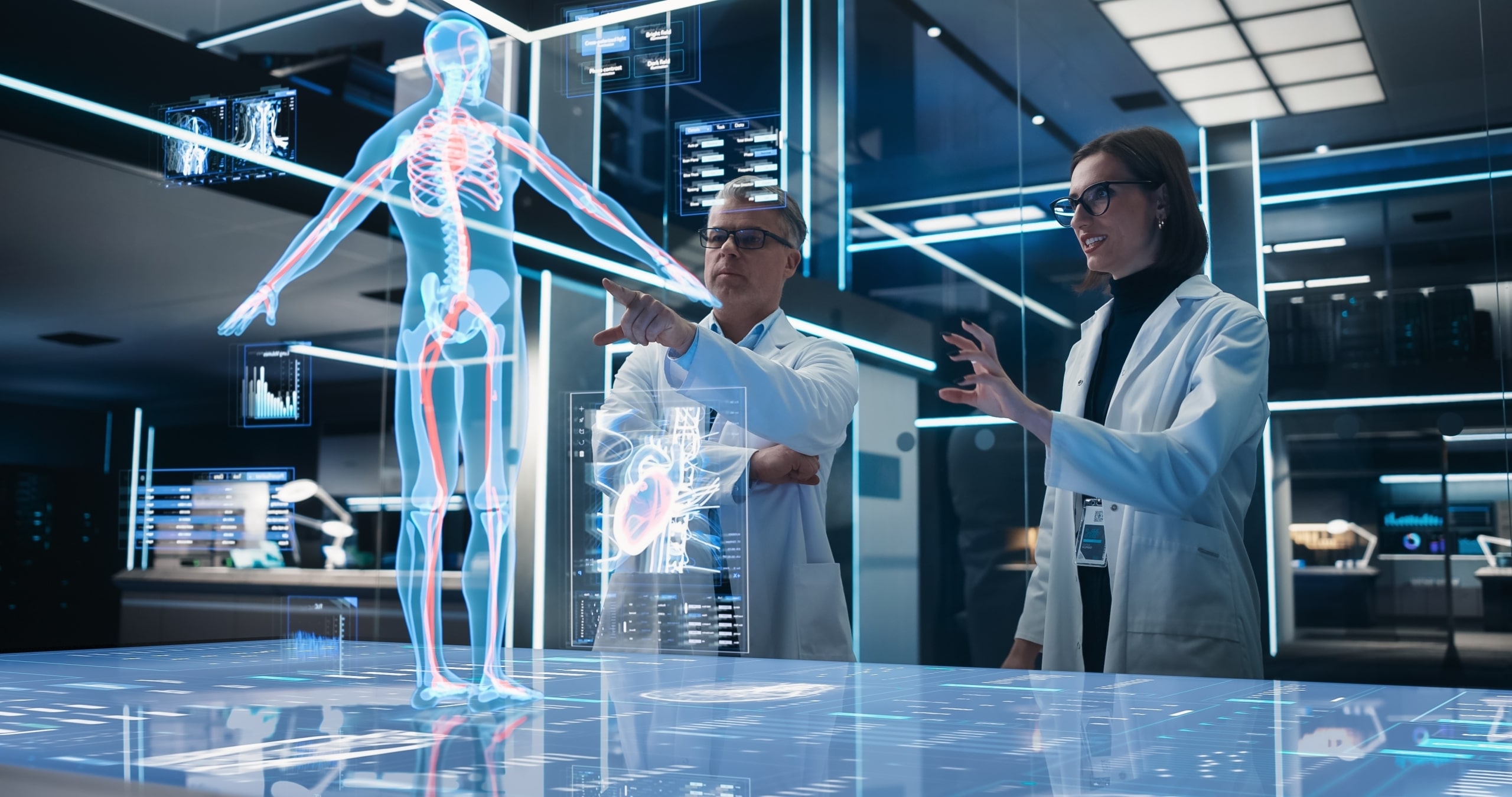 Two bioengineers working with computer concept of the human body