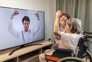 Elderly Asian woman in a telehealth physical therapy appointment